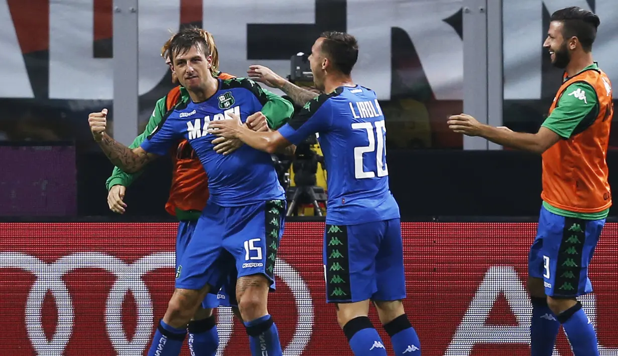 Bek Sassuolo, Francesco Acerbi (kiri) melakukan selebrasi usai mencetak gol kegawang AC Milan pada liga Italia di San Siro, Milan (3/9). AC Milan menang dramatis atas Sassuolo dengan skor 4-3. (AFP Photo/Marco Bertorello)