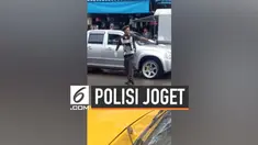 Seorang polisi Thalland berjoget di tengah jalan sambil mengatur lalu lintas. Tingkah lucu polisi ini mencuri perhatian warga sekitar.