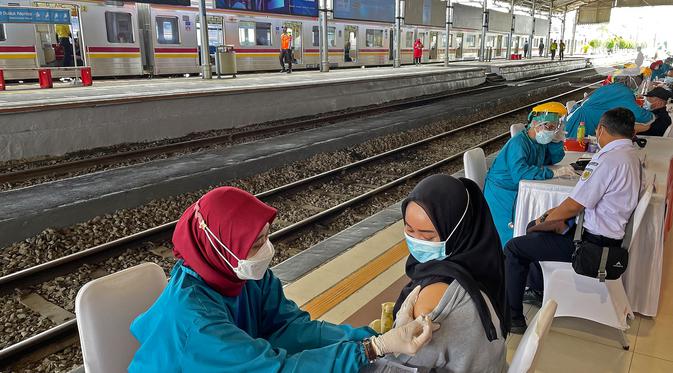 Tenaga medis menyuntikkan vaksin kepada petugas dan penumpang kereta api di Stasiun Bogor, Jawa Barat, Kamis (17/6/2021). Pelaksanaan vaksinasi massal di Stasiun Bogor itu menyasar petugas stasiun, pekerja di stasiun dan penumpang kereta. (Liputan6.com/Herman Zakharia)