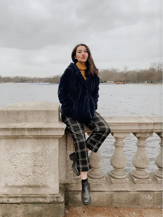 Berlibur ke London di musim dingin, Aaliyah tampil dengan jaket hitam berbulu dipadukan turtleneck coklat dan celana kotak-kotak hitamnya. [@aaliyah.massaid]