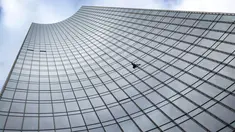 Pendaki kota Prancis, Alain Robert saat berusaha memanjat gedung XYZ di Frankfurt am Main, Sabtu (28/9/2019). Alain yang dikenal sebagai "The French Spiderman" kembali memanjat gedung tinggi di kota Jerman tersebut. (AFP Photo/Daniel Roland)