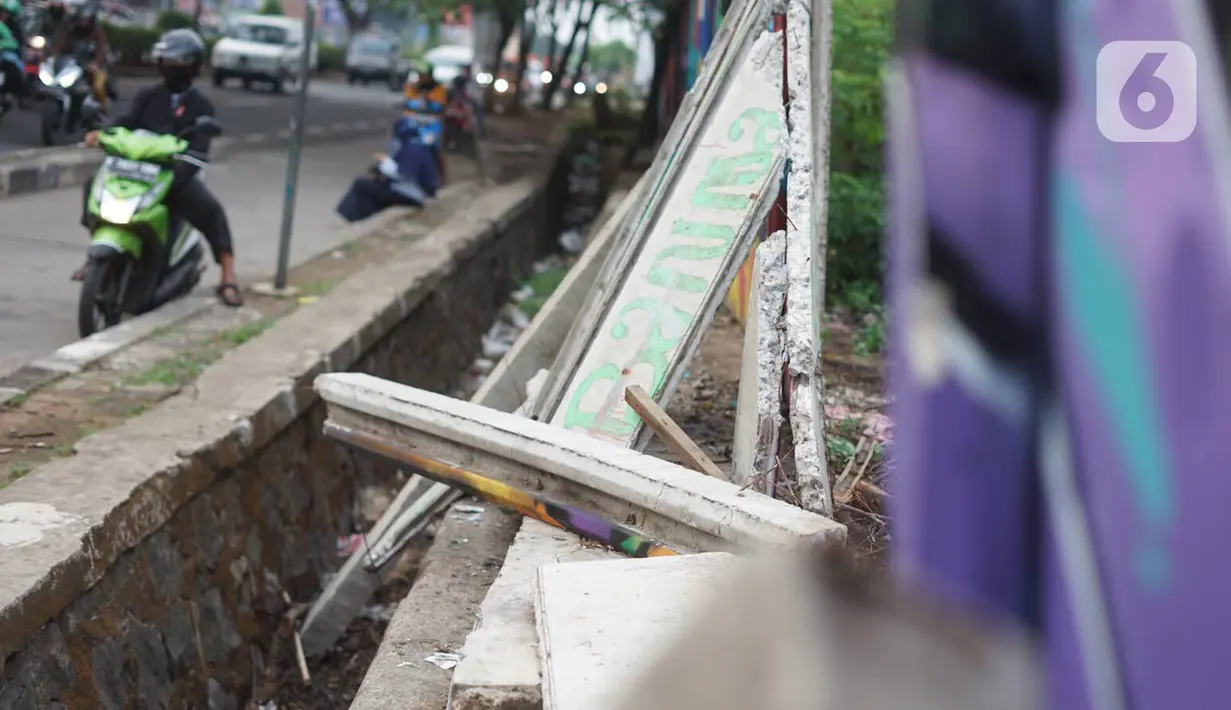 Kondisi tembok Jalan Juanda yang ambruk di kawasan Depok, Jawa Barat, Senin (2/12/2019). Kondisi tembok yang dipenuhi mural tersebut mulai rapuh dan sebagian sisinya telah ambruk serta miring sehingga membahayakan pejalan kaki. (Liputan6.com/Immanuel Antonius)