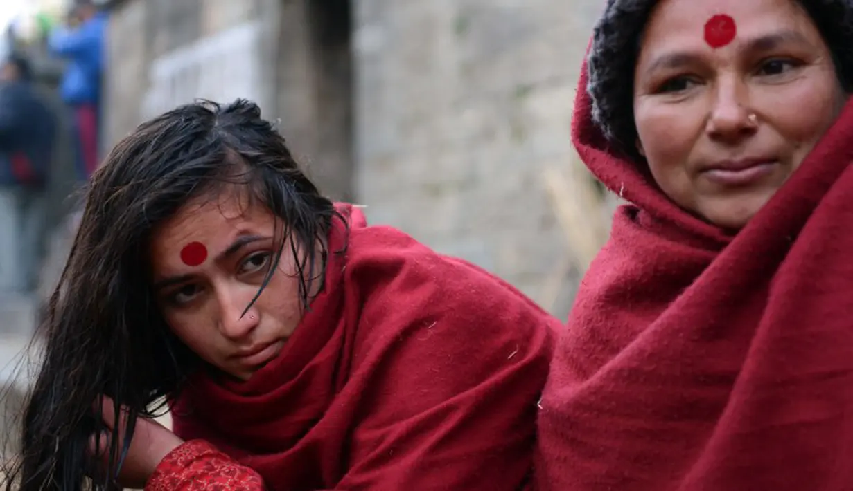 Seorang wanita Nepal mengeringkan rambutnya usai mandi di Sungai Bagmati saat Festival Swasthani, Kathmandu, Selasa (20/1/2015). (AFP Photo/Prakash Mathema)