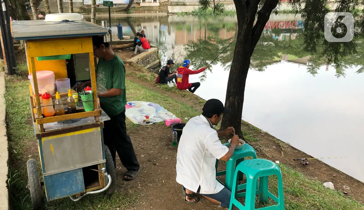 Warga beraktivitas di sekitar Setu Cibinong, Jawa Barat, Kamis (11/6/2020). Meskipun spanduk larangan penutupan telah dipasang, namun sebagian warga tetap nekat beraktivitas di kawasan tersebut untuk memancing ikan atau berekreasi. (Liputan6.com/Immanuel Antonius)