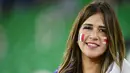Fans Prancis tersenyum saat menyaksikan laga Prancis melawan Polandia pada laga Piala Dunia 2022 di Stadion Al-Thumama, Minggu (4/12/2022). (AFP/Javier Soriano)