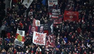 Tanpa kawalan sejumlah pemain inti, Setan Merah berhasil meredam tekanan Newcastle United. Tampak dalam foto, para penggemar United mengibarkan bendera menjelang dimulainya pertandingan sepak bola Liga Premier Inggris antara Manchester United dan Newcastle United di di Stadion Old Trafford, pada 26 Desember 2025 waktu setempat atau Sabtu (27/12/2025) dini hari WIB. (Darren Staples/AFP)