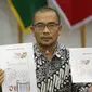 Komisioner KPU Hasyim Asy'ari menunjukkan desain pasangan capres nomor urut 01 saat rapat di Gedung KPU, Jakarta, Senin (29/10). Rapat membahas Penyampaian dan Penetapan Desain Alat Peraga Kampanye (APK). (Liputan6.com/Angga Yuniar)