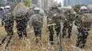 Polisi dilempari jerami oleh peternak dan petani yang melakukan aksi protes saat pertemuan Menteri-menteri Eropoa di Brussels, Belgia, 7 September 2015. Aksi tersebut menuntut bantuan harga murah dan biaya yang tinggi. REUTERS/Yves Herman)