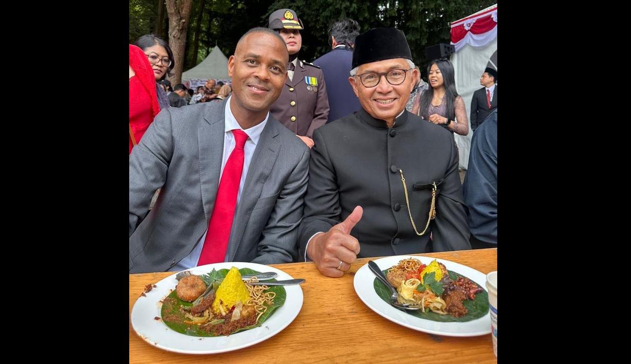 <p>Pelatih Timnas Indonesia, Patrick Kluivert (kiri) berfoto bersama dengan Dubes Indonesia untuk Belanda, Petahana Mayerfas saat menyantap nasi kuning setelah mengikuti upacara pengibaran bendera merah putih dalam perayaan hari ulang tahun kemerdekaan Indonesia ke-80 di KBRI Den Haag, Belanda, Minggu (17/08/2025). (Source: Twitter)</p>