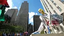 Balon penari balet karya seniman Jeff Koons, di Rockefeller Center, New York City, AS, Jumat (12/5). Keberadaan balon penari balet menjadi ajang foto pengunjung Rockefeller Center. (Spencer Platt / Getty Images / AFP)