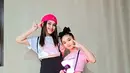 Ayu Ting Ting memilih mengenakan cropped t-shirt berwarna putih dengan motif hati pink, dipadu mini pleated skirt, kaus kaki panjang dan midi heels loafers berwarna hitam. Penampilan Ayu Ting Ting semakin manis dengan beanie pink dan backpack kecil. [Foto: Instagram/ayutingting92]