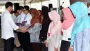 Presiden Jokowi menyerahkan secara simbolis KIP (Kartu Indonesia Pintar), Program Keluarga Harapan (PKH) dan bansos pangan rastra (beras sejahtera) di Kota Banjarbaru, Kalimantan Selatan (26/3). (Liputan6.com/Pool/Biro Setpres)
