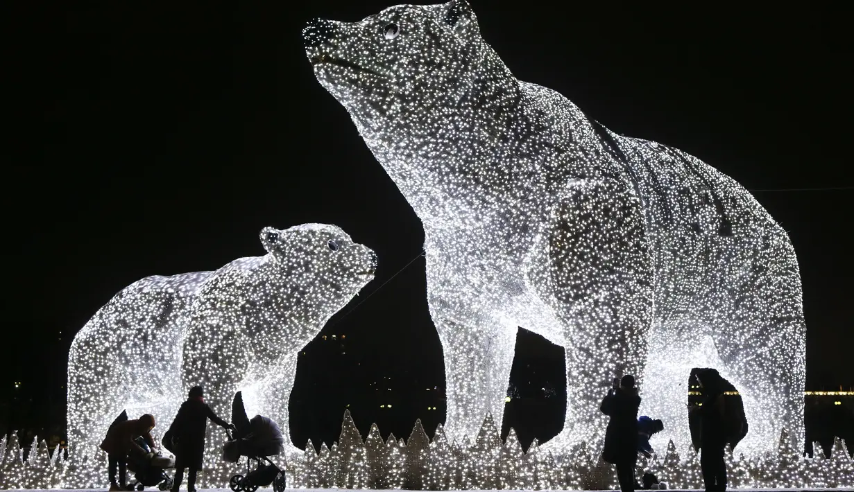 Orang-orang melihat instalasi lampu yang dipasang untuk menyambut libur Tahun Baru dan Natal Ortodoks di Moskow, Rusia, pada 29 Desember 2020. (Xinhua/Alexander Zemlianichenko Jr)