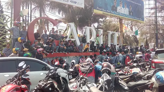 Nampak para peserta aksi demo pelajar SMK/SMA di Garut, Jawa Barat, tengah berdiri di salah satu ikon kota Garut, mereka lebih memilih bolos daripada mengikuti jam pelajaran di sekolah