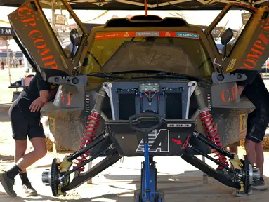 Sejumlah mekanik tengah memeriksa mobil menjelang ajang Reli Dakar 2025 pada Rabu (01/01/2025) waktu setempat di Bisha, Arab Saudi. Ajang tersebut akan berlangsung pada 3 hingga 17 Januari 2025. (AFP/Valery Hache)