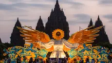 Orang-orang berkumpul di depan "Sunflower Angel", instalasi seni fiberglass setinggi sembilan meter karya seniman lokal Arrofi Ramadhan, di Candi Prambanan, kompleks candi Hindu abad ke-9 yang terdaftar sebagai Situs Warisan Dunia UNESCO, Sleman, Yogyakarta, pada Sabtu 6 Juni 2026. (DEVI RAHMAN/AFP)