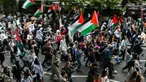 Para pengunjuk rasa memegang plakat dan mengibarkan bendera Palestina saat mereka mengambil bagian dalam “Pawai Nasional untuk Gaza”, di pusat kota London, pada 8 Juni 2024. (JUSTIN TALLIS/AFP)