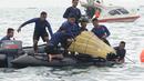 Tim SAR mengevakuasi bagian tubuh penumpang pesawat Sriwijaya Air SJ 182 di perairan Kepulauan Seribu, Jakartra, Minggu (10/1/2021). Sriwijaya Air SJ 182 hilang kontak empat menit usai lepas landas dari Bandara Soetta. (merdeka.com/Arie Basuki)