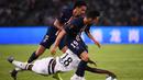Bek PSG, Marquinhos, menghindari tekel gelandang Rennes, Eduardo Camavinga, pada laga Piala Super Prancis di Stadion Shenzhen, China, Sabtu (3/8). PSG menang 2-1 atas Rennes. (AFP/Franck Fife)