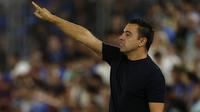 Pelatih Barcelona, Xavi Hernandez tercatat menjadi pelatih termuda keempat pada Liga Champions 2023/2024. Saat ini juru taktik yang mulai menangani Blaugrana sejak awal musim 2021/2022 menginjak usia 43 tahun. Hingga kini ia telah mencatatkan 62 kali menang, 18 imbang dan 19 kali kalah dalam 99 laga di semua ajang kompetisi. Pada matchday pertama Liga Champions 2023/2024 Barcelona menang telak 5-0 atas FC Antwerp. (AFP/Javier Soriano)