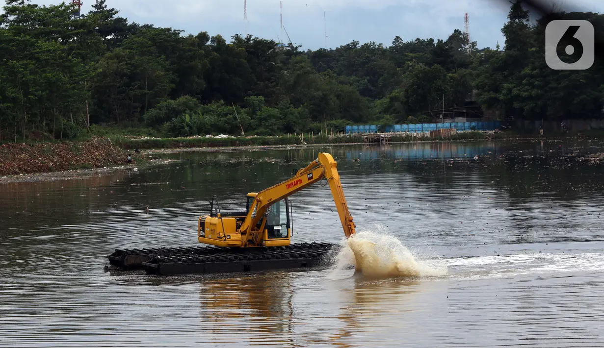 Petugas menggunakan alat berat jenis Eksavator Amphibi melakukan aktivitas pengerukan di area Situ Pengarengan, Depok, Jawa Barat, Selasa (12/1/2021). Pengerukan dilakukan untuk menjaga kedalaman setu terlebih di musim penghujan. (Liputan6.com/Helmi Fithriansyah)