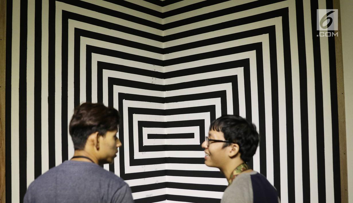 Pengunjung berbincang di depan karya yang dipajang dalam pameran bersama bertajuk 'Mutual Unknown' di Galeri Nasional, Jakarta, Sabtu (3/6). Pameran ini mengajak pengunjung untuk berinteraksi dengan 9 pameris. (Liputan6.com/Immanuel Antonius)