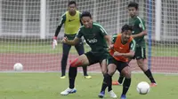 Pemain Timnas Indonesia U-22, Andy Setyo, berebut bola dengan Gian Zola saat latihan di Stadion Madya Senayan, Jakarta, Selasa (22/1). Latihan ini merupakan persiapan jelang Piala AFF U-22. (Bola.com/Yoppy Renato)