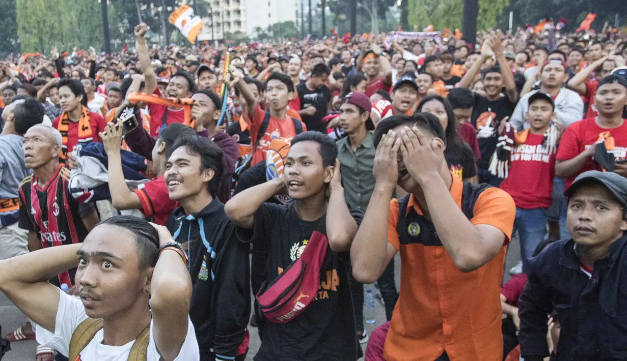 Suporter Persija Jakarta, The Jakmania, memberi dukungan saat nonton bareng di Plaza Timur Senayan, Jakarta, Minggu (9/12). Persija juara Liga 1 setelah menang 2-1 atas Mitra Kukar. (Bola.com/Peksi Cahyo)
