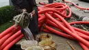 Seorang pekerja menyiapkan air untuk proyek pemasangan instalasi listrik bawah tanah di Jakarta, Jumat (28/10). Para buruh lepas ini mengaku mendapat upah sebesar Rp.200.000 per hari. (Liputan6.com/Angga Yuniar)