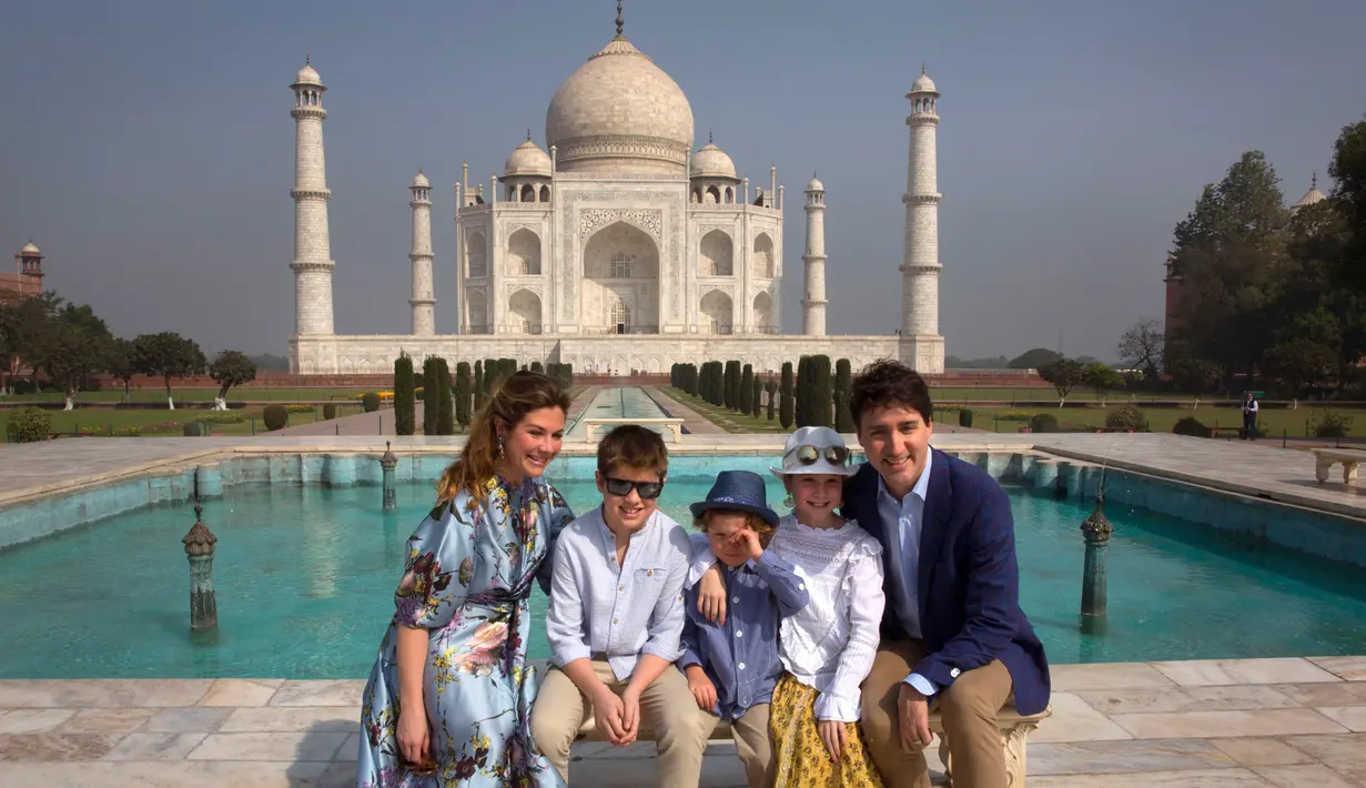 PM Kanada Justin Trudeau bersama sang istri, Sophie Gregoire Trudeau serta tiga anaknya berpose di depan Taj Mahal di sela-sela kunjungan ke India, Minggu (18/2). Ini adalah kunjungan pertama Tredeau ke India sejak menjabat pada 2015. (AP/Manish Swarup)