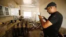 Anggota pasukan kontraterorisme Irak mengambil gambar senjata yang berada di bangunan yang digunakan sebagai pabrik senjata militan ISIS yang berhasil ditemukan di Fallujah, Irak, Kamis (23/6). (REUTERS/Thaier Al-Sudani)