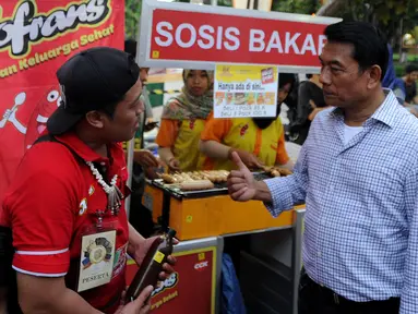 Ketua HKTI yang juga mantan Panglima TNI Moeldoko berbincang dengan peserta pameran di Festival Panen Raya Nusantara (Parara) di Taman Menteng, Jakarta, Minggu (15/10). Lebih dari 85 komunitas lokal ikut dalam festival tersebut. (Liputan6.com/Ari)