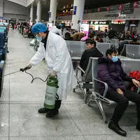 Petugas menyemprotkan cairan disinfektan di Stasiun Kereta Api Yingtan di Nanchang di Provinsi Jiangxi Tengah, China (22/1/2020). Penyemprotan dilakukan untuk mencegah virus corona menyebar ke kota lain. (AFP Photo/STR)