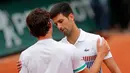 Petenis Serbia, Novak Djokovic berjabat tangan dengan petenis Austria Dominic Thiem usai pertandingan perempatfinal turnamen tenis Prancis Terbuka di stadion Roland Garros, Paris (7/6). Djokovic kalah 7-6, 6-3, 6-0. (AP Photo/Christophe Ena)