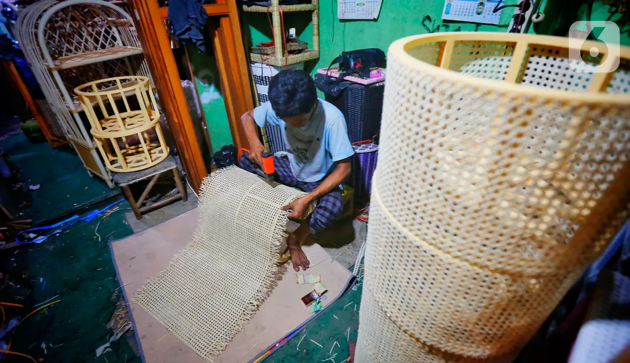Perajin menyelesaikan pembuatan kerajinan dari rotan di kawasan Tangerang, Banten, Rabu (17/2/2021). Pandemi corona memukul banyak sektor usaha tak terkecuali UMKM akibat adanya pembatasan aktivitas masyarakat yang membuat omzet penjualan kerajinan rotan menurun. (Liputan6.com/Angga Yuniar)