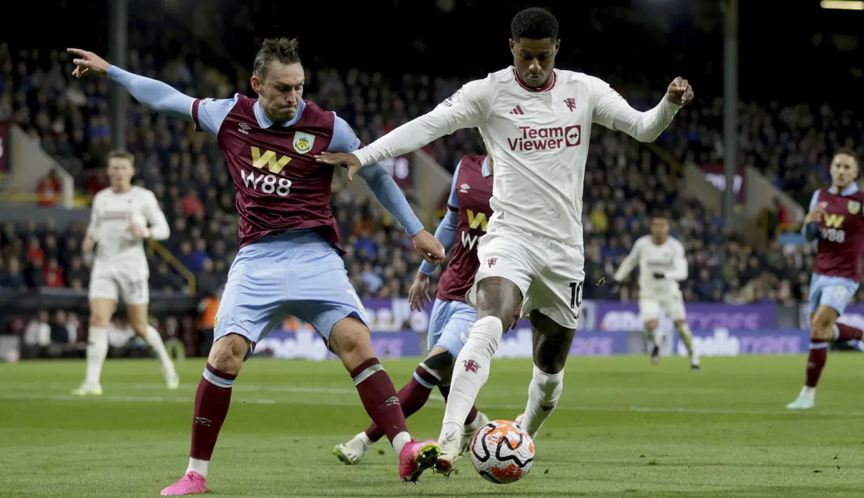 Penyerang Manchester United Marcus Rashford berbeut bola dengan bek Burnley Connor Roberts pada pekan ke-6 Liga Inggris 2023/2024 di Stadion Turf Moor, Minggu (24/9/2023) dini hari WIB. (Ian Hodgson/PA via AP)