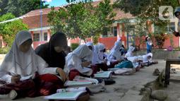 Murid Kelas VI belajar di halaman sekolah di SDN Sukagalih, Kampung Benda, Desa Mekargalih, Kecamatan Cikalong Kulon, Cianjur Senin (29/8/2022). Akibat tiga ruangan kelas rusak berat dan terancam ambruk, sejumlah murid terpaksa belajar di halaman dan musholla sejak awal pembelajaran tatap muka Juli kemarin. (merdeka.com/Arie Basuki)