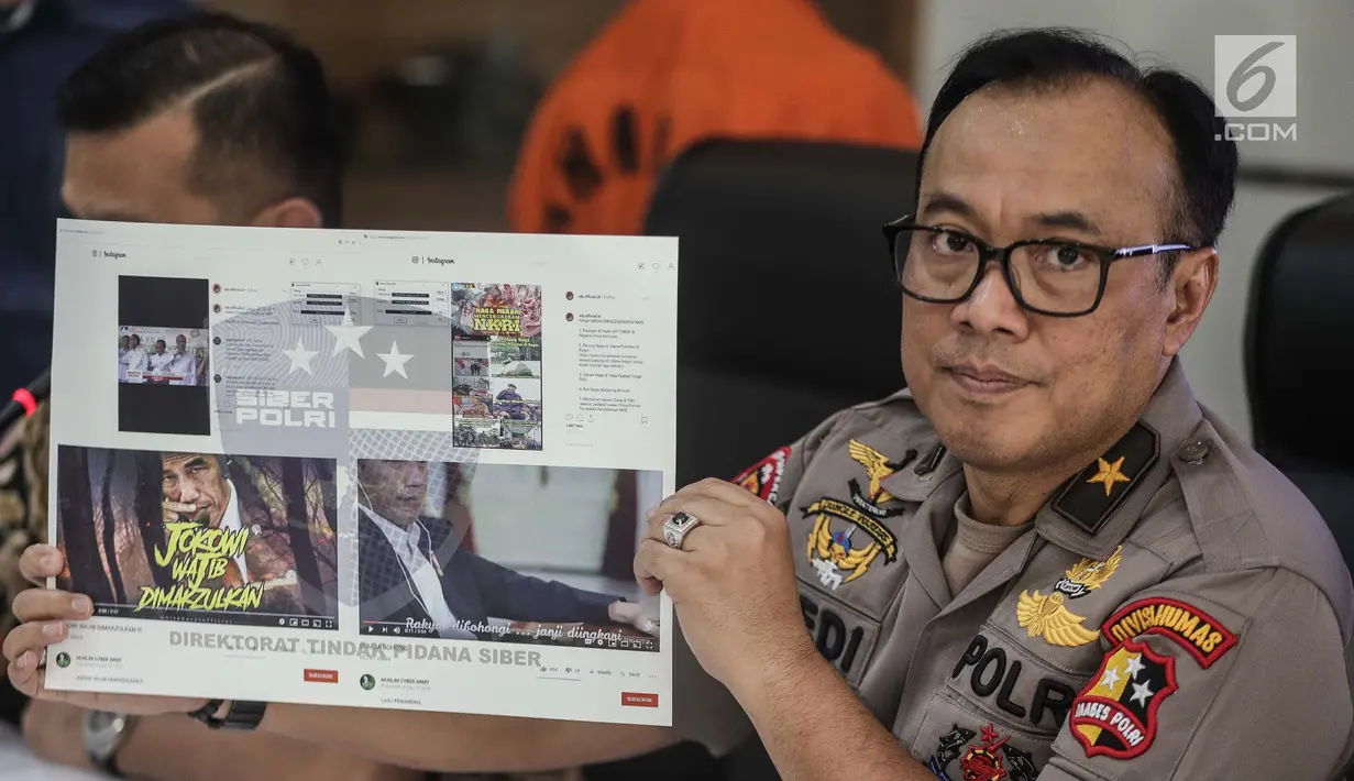 Karopenmas Divisi Humas Polri Brigjen Pol Dedi Prasetyo menunjukkan barang bukti kasus propaganda dan penyebaran hoaks SARA di Mabes Polri, Jakarta, Jumat (28/6/2019). Polisi menyita barang bukti laptop, hp, hardisk, dan atribut laskar FPI. (Liputan6.com/Faizal Fanani)