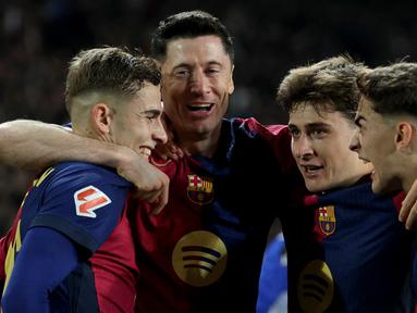 Robert Lewandowski (tengah kiri) merayakan gol bersama para pemain Barcelona dalam laga lanjutan Liga Spanyol 2024/2025 melawan Osasuna di Estadi Olimpic Lluis Companys, Barcelona, Spanyol, Jumat (27/03/2025) waktu setempat. (AFP/Lluis Gene)