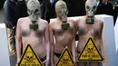 Sejumlah demonstran menggunakan masker gas saat unjuk rasa menolak London Fashion Week, Inggris (19/2). Alasan mereka menolak acara fashion tersebut karena pemakaian bulu binatang dalam pembuatan busananya. (REUTERS / Neil Balai)