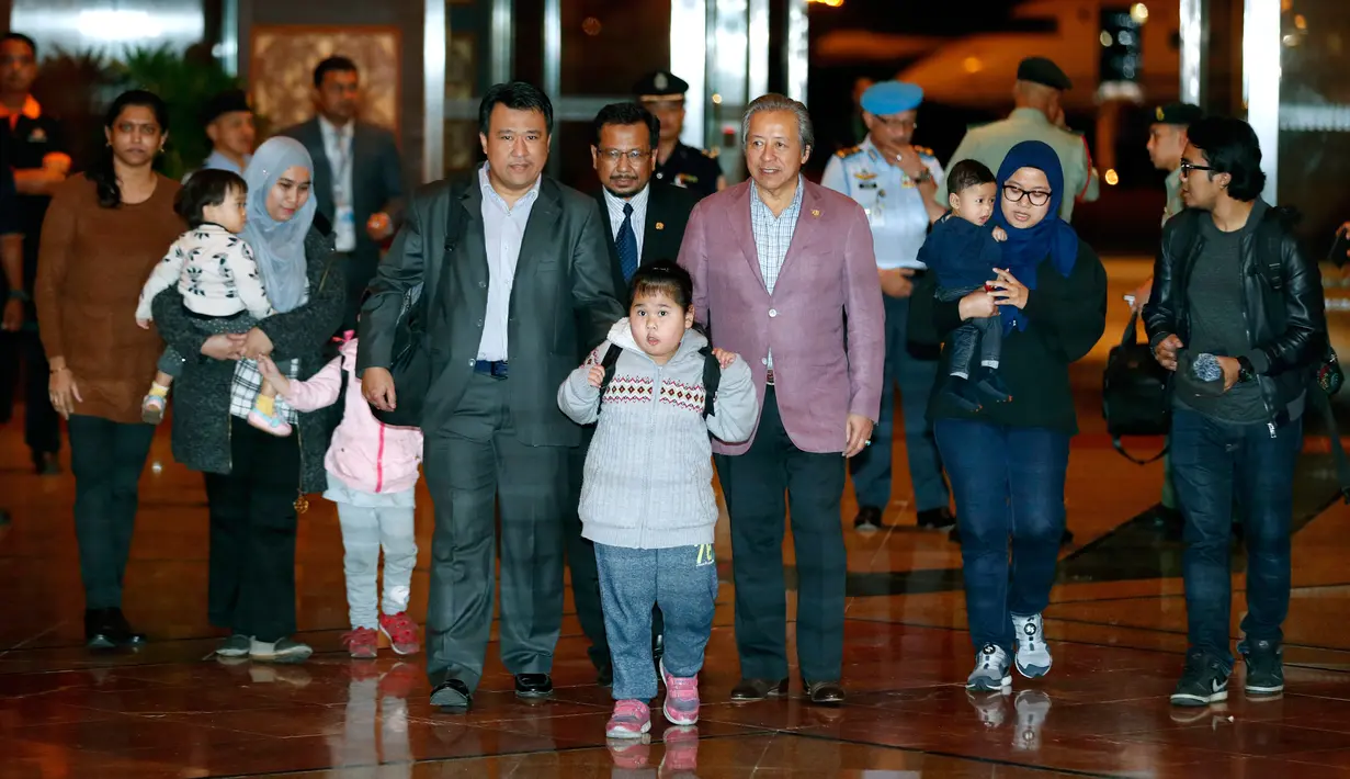 Warga Malaysia yang sempat dilarang meninggalkan Korea Utara akhirnya tiba di Bandara Internasional Kuala Lumpur, Sepang, Jumat (31/3). Pemulangan sembilan warga Malaysia yang berada di Korut itu ditukar dengan jasad Kim Jong-nam. (AP Photo/Vincent Thian)