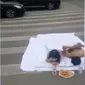 Hanya demi foto, pasangan ini sampai ganggu lalu-lintas di jalan raya. (dok. screenshot video Twitter @SCMPNews)