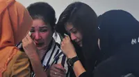 Risma saat mendekati keluarga penumpang yang tidak bisa menyembunyikan kesedihannya karena pesawat  AirAsia QZ8501 belum juga ditemukan, Surabaya, Jawa Timur, Senin   (29/12). (Liputan6.com/Johan Tallo)