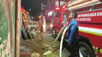 Petugas Diskar PB Kota Bandung tengah berupaya memadamkan api saat tiba di lokasi kebakaran, Selasa (29/30/2020).(Liputan6.com/ Dok.Diskar PB Kota Bandung)