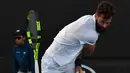 Petenis Prancis Benoit Paire melempar raketnya saat pertandingan putaran pertama melawan petenis Spanyol Guillermo Garcia-Lopez pada hari kedua turnamen tenis Australia Terbuka di Melbourne (16/1). (AFP Photo/Paul Crock)