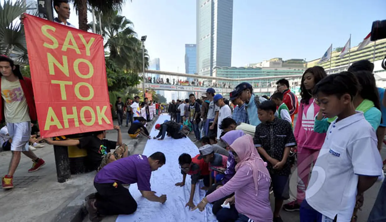 Sejumlah warga membubuhkan tanda tangan mendukung pemakzulan Gubernur DKI Basuki Tjahaja Purnama alias Ahok di Bundaran HI, Jakarta, Minggu (22/2/2015). Mereka melakukan aksi ini karena kebijakan Ahok dinilai tak pro-rakyat. (Liputan6.com/Faizal Fanani)
