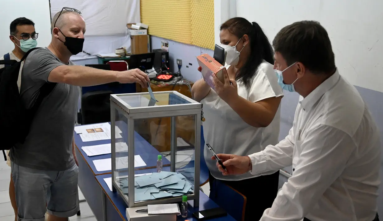 <p>Seorang warga negara Prancis memasukkan kertas suara ke kotak saat putaran kedua pemilihan presiden Prancis di sebuah tempat pemungutan suara di Kerobokan, Bali, Minggu (24/4/2022). Hasil pemilu ini, nantinya akan menjadi penentu apakah Presiden Prancis Emmanuel Macron akan tetap mempertahankan jabatannya atau kehilangan posisinya tersebut. (SONNY TUMBELAKA / AFP)</p>