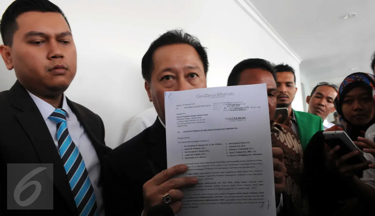 Ketua tim kuasa hukum PPP kubu Djan Faridz, Humphrey R Djemat menunjukkan sebuah dokumen usai sidang perdana di PN Jakarta Pusat, Selasa (15/3). Hakim menunda sidang gugatan terhadap Presiden Jokowi dan 2 menterinya tersebut. (Liputan6.com/Helmi Afandi)