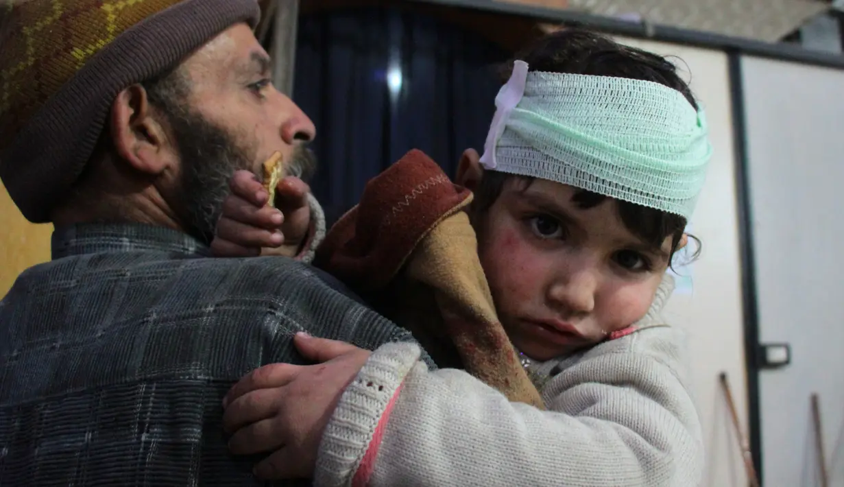Ekspresi seorang anak yang terluka akibat serangan udara pasukan Assad di wilayah Ghouta timur, Suriah (7/2). Karena banyak memakan korban PBB pun meminta kepada sejumlah pihak untuk melakukan gencatan senjata demi kemanusiaan. (AFP Photo/Hamza Al-Ajweh)