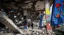 Abdelatty juga menyebut Jalur Gaza dan Tepi Barat sebagai bagian integral dari negara Palestina merdeka hingga otoritas mendapatkan kewenangan penuh dan dapat ditempatkan kembali. Tampak dalam foto, seorang anak laki-laki berdiri di tengah mural yang dilukis di sebuah bangunan yang hancur di kamp pengungsi Maghazi di luar Deir al-Balah pada Senin 8 Desember 2025. (EYAD BABA/AFP)